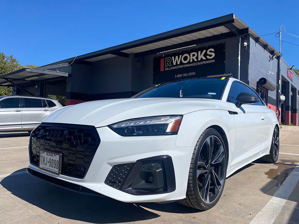 car with rworks logo in background white car