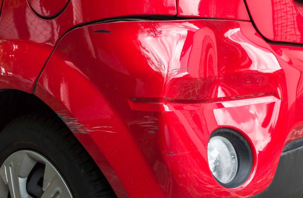 how to fix bumper dent - red car with dented bumper